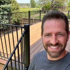 Dan standing beside a finished deck project Parker, Colorado